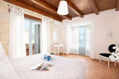 a bedroom with a bed and a table with books at Beachfront villa Turquoise with private pool, BBQ and ping pong table in Chania Town