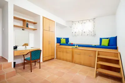 a kitchen with a table and a blue bench at Beachfront villa Turquoise with private pool, BBQ and ping pong table in Chania Town