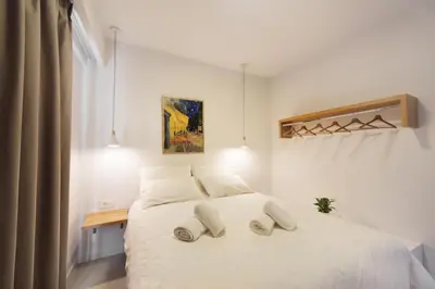 a bedroom with a white bed with two pillows on it at Terpsis Estate in Chania Town