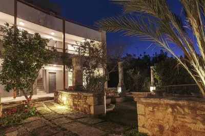 an exterior view of a house at night at Terpsis Estate in Chania Town