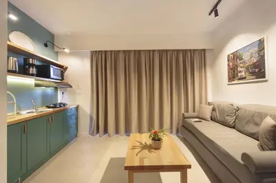 a living room with a couch and a table at Terpsis Estate in Chania Town