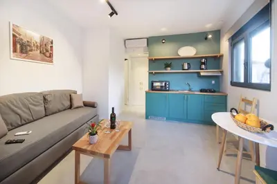 a living room with a couch and a table at Terpsis Estate in Chania Town