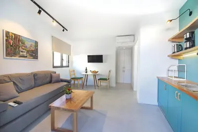 a living room with a couch and a table at Terpsis Estate in Chania Town