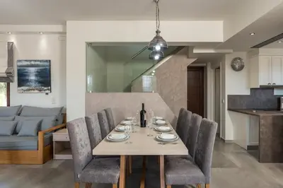 a dining room and living room with a table and chairs at Villa Nina with Private Pool in Kolymvari