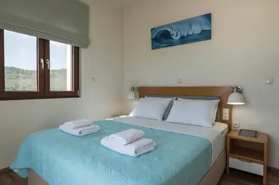 a bedroom with a bed with towels on it at Villa Nina with Private Pool in Kolymvari