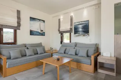 a living room with two couches and a table at Villa Nina with Private Pool in Kolymvari