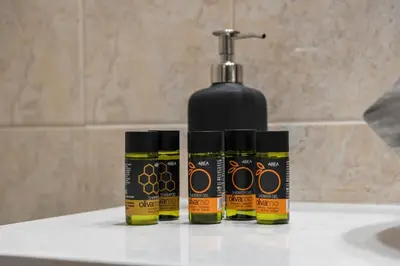 three bottles of mustard on a counter next to a soap dispenser at CALMERA Luxury Living in Chania Town