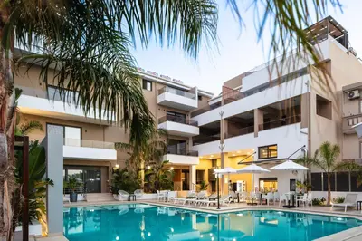 an exterior view of a hotel with a swimming pool at Sapphire Blue Suites in Kissamos