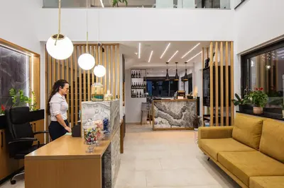 a woman standing at a counter in a salon at Sapphire Horizon Suites in Kissamos