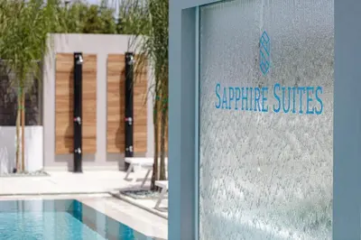 a sign for a swimming pool in front of a building at Sapphire Horizon Suites in Kissamos