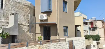 a building with a basketball hoop on the side of it at Blueonar in Chania Town