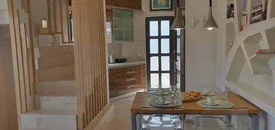 a kitchen with a wooden table and a staircase at Blueonar in Chania Town