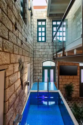 a swimming pool with two blue chairs in a building at Estia Luxury Living in Chania Town