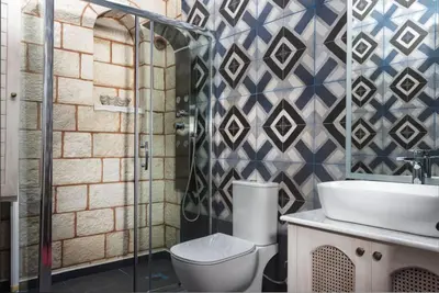 a bathroom with a shower and a toilet and a sink at Estia Luxury Living in Chania Town