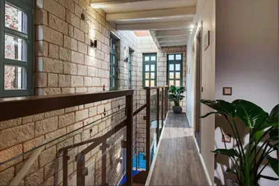 a brick hallway with a staircase and a brick wall at Estia Luxury Living in Chania Town
