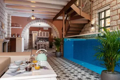 a kitchen and living room with a pool in a house at Estia Luxury Living in Chania Town