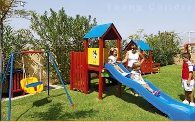 a group of children playing on a playground at Sissy Village All Suite Hotel in Kounoupidhianá