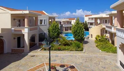 a courtyard of a house with a swimming pool at Sissy Village All Suite Hotel in Kounoupidhianá