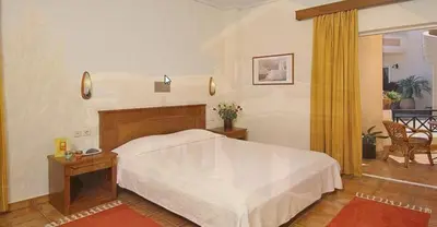 a bedroom with a large white bed in a room at Sissy Village All Suite Hotel in Kounoupidhianá