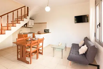 a living room with a couch and a table at Villa Krini in Kalathas