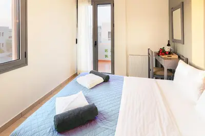 a bedroom with a bed with two pillows on it at Villa Krini in Kalathas