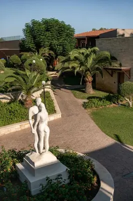 a statue of a woman in a park at Caldera Creta Paradise in Plataniás