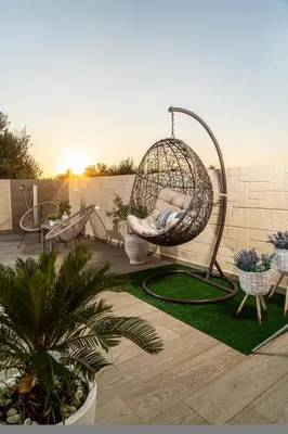 a swing sitting on top of a patio at Villa Elisabeth View in Plataniás