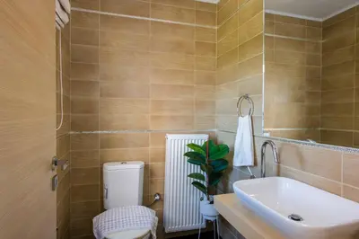 a bathroom with a toilet and a sink at Villa Elisabeth View in Plataniás
