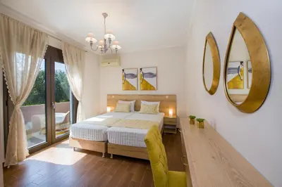 a bedroom with a bed and a large mirror at Villa Elisabeth View in Plataniás