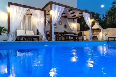 a pool with a gazebo and a table and chairs at Villa Elisabeth View in Plataniás