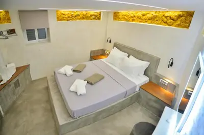 a bedroom with a bed with two towels on it at CAVE Luxury House in Kissamos