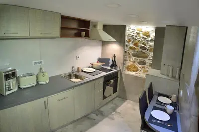 a kitchen with a sink and a counter top at CAVE Luxury House in Kissamos