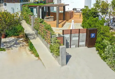 a retaining wall with plants on the side of a house at CAVE Luxury House in Kissamos