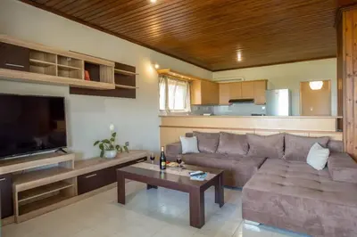 a living room with a couch and a table at Blue and green in Chania Town
