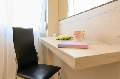 a black chair sitting next to a counter with a mug at Just For Two in Chania Town