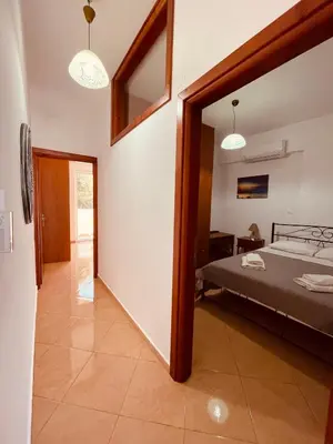 a bedroom with a bed and a mirror at Alcyone Apartment in Kissamos