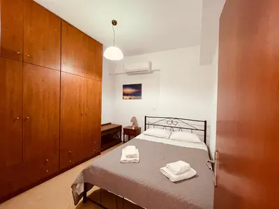 a bedroom with a bed with two towels on it at Alcyone Apartment in Kissamos