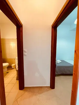 a door leading to a bathroom with a bedroom at Alcyone Apartment in Kissamos