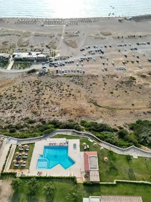 an aerial view of a parking lot next to the beach at Panorama Hotel in Falasarna