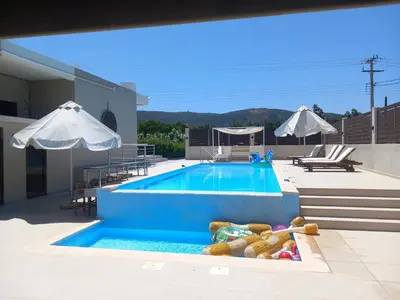 a swimming pool with toys and umbrellas on a building at Giannis Villa in Skinés
