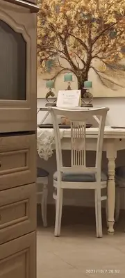 a table with a chair and a table with a sign on it at BLUE EYES VILLA in Chania Town