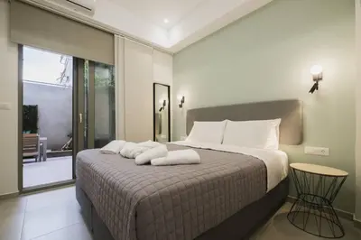 a bedroom with a large bed with white pillows at Peris 5 with Yard steps to Bus St & Old Town in Chania Town
