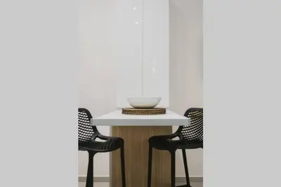 a table with two chairs and a bowl on top of it at Peris 5 with Yard steps to Bus St & Old Town in Chania Town