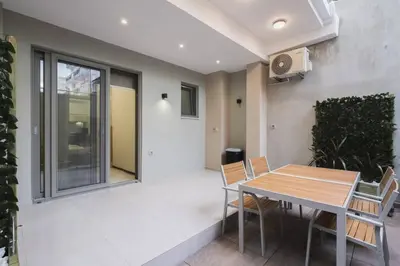 a dining room with a table and chairs at Peris 5 with Yard steps to Bus St & Old Town in Chania Town