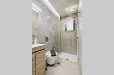 a bathroom with a shower and a toilet and a sink at Peris 5 with Yard steps to Bus St & Old Town in Chania Town
