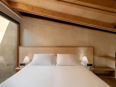 a bedroom with a large bed with two white pillows at Casa Sorvolou in Chania Town