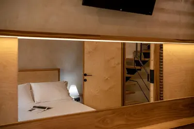 a room with a bed and a tv and a mirror at Casa Sorvolou in Chania Town