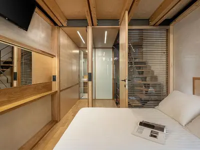 a bedroom with a bed with a book on it at Casa Sorvolou in Chania Town