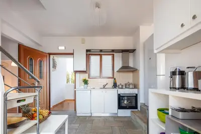 a kitchen with white cabinets and a stove at Villa Aliki ,Aegean Sea Breeze 750m from the Beach! in Chania Town
