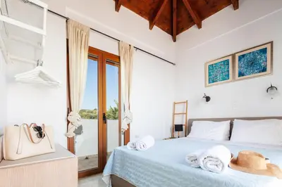 a bedroom with a bed with towels on it at Villa Aliki ,Aegean Sea Breeze 750m from the Beach! in Chania Town